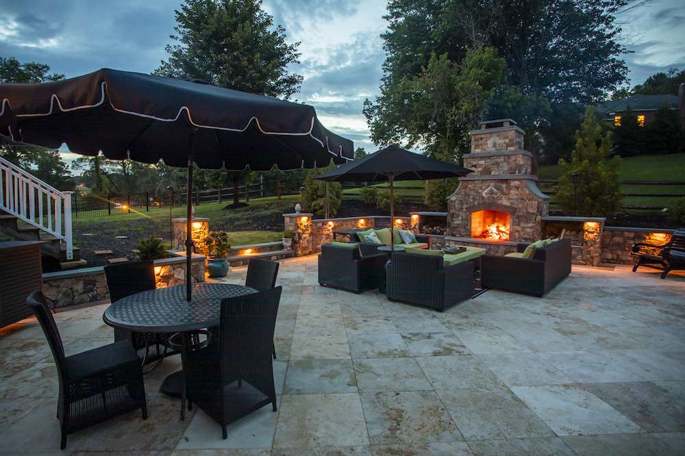outdoor-patio-with-landscape-lighting-and-outdoor-fireplace