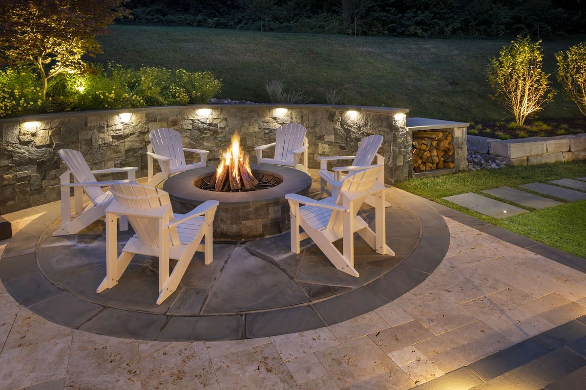 fire pit on patio with seating and lighting