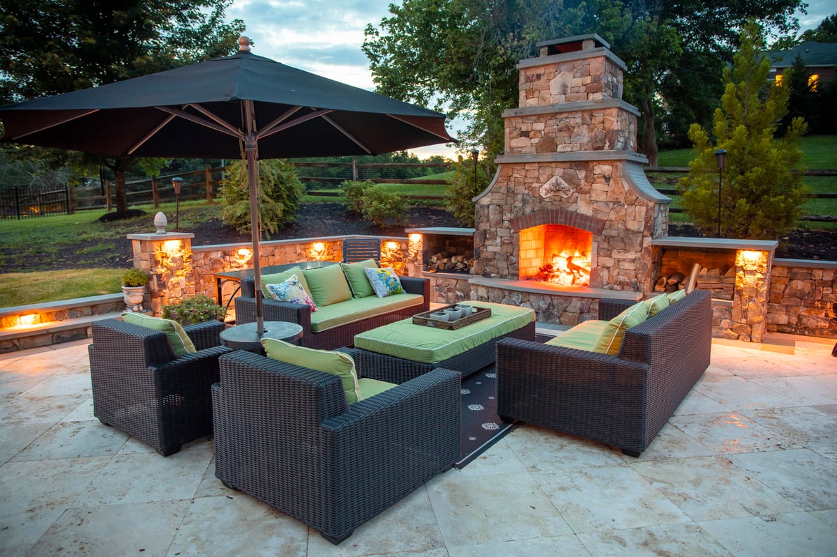 outdoor fireplace with seating and patio