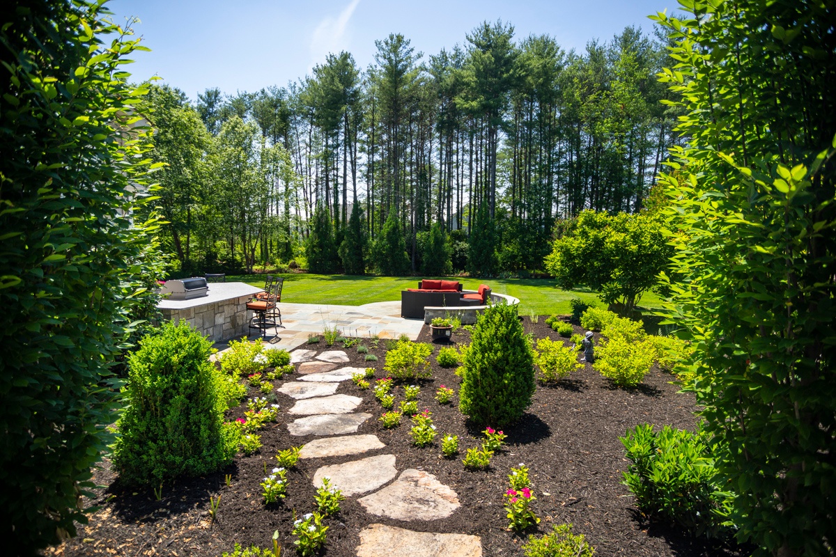 stone steppers with plantings leading to patio